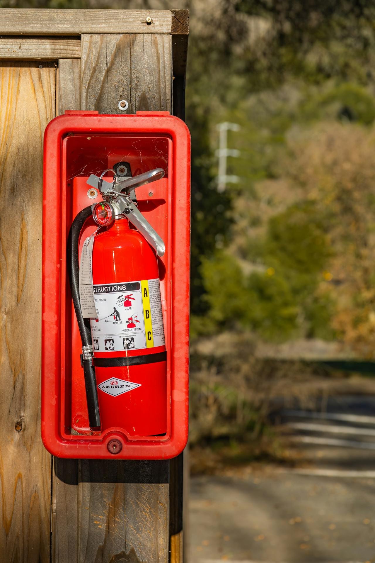 A Fire Extinguisher Mounted on a Wooden Post